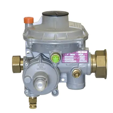 Un regulator de presiune pentru gaz compact, gri, cu un capac rotund cu căpăcel negru, un buton portocaliu, o carcasă rotundă inferioară cu inscripția „Pull to reset”, o etichetă roz și câte o piuliță de alamă de fiecare parte.
