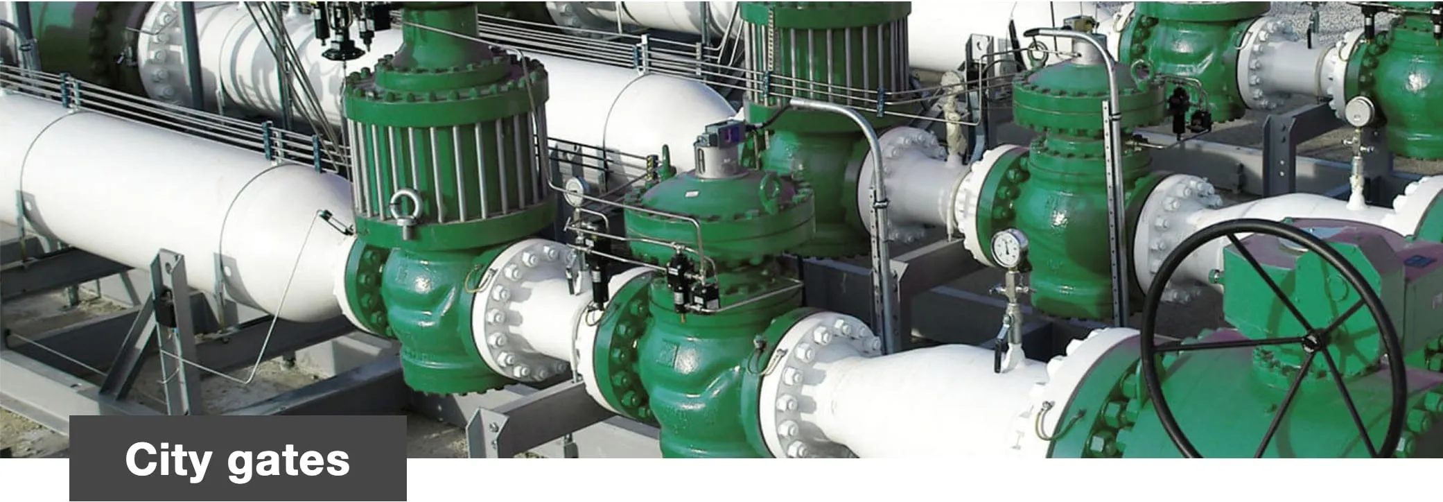 Green valves and white pipework, with the caption City gates in the lower left corner.